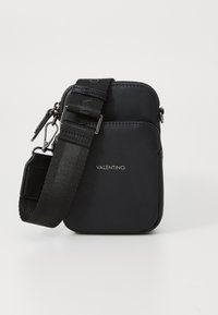Black crossbody bag made of smooth fabric, featuring a zipper closure, an adjustable nylon strap, and a front logo detail.