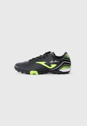 Black soccer cleat with green accents. Synthetic upper, textured design, lace closure, and lightweight sole. Ideal for turf surfaces.