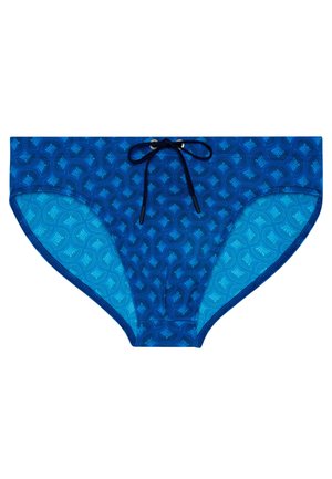 Siniset miesten uimahousut, joissa tummansininen geometrinen kuvio ja musta kiristysnyöri vyötäröllä, kuvattuna tasaisesti valkoisella taustalla.