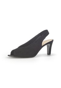 Black suede slingback shoe with open toe, curved design, and a slender high heel. Features a soft texture and minimalistic style.