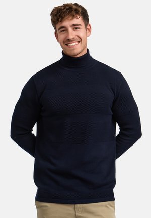 Mørkeblå høyhalset genser med teksturerte mønstre og glatte striper, laget av strikket materiale. Standard passform og lange ermer.