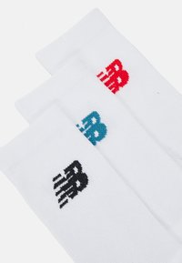 Three pairs of white athletic socks with ribbed texture, featuring contrasting colored logos: black, blue, and red.
