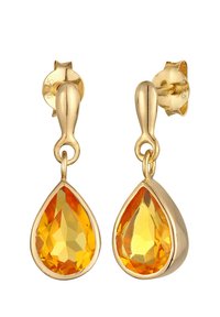 Boucles d'oreilles pendantes en ton or avec des pierres facettées jaunes en forme de goutte d'eau, maintenues par des fermoirs papillon, présentant une finition polie.