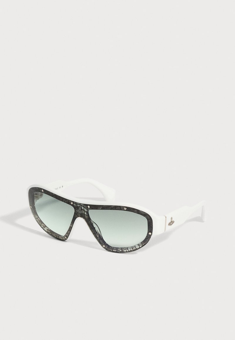 Lunettes de soleil blanches avec de grandes montures noires à motifs et des verres dégradés sur un fond clair.