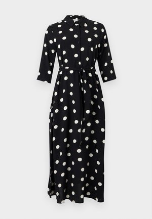 Schwarzes Midi-Hemdkleid mit weißen Polka-Punkten, dreiviertel Ärmeln, Knopfleiste vorne, Kragen und Taillengürtel zum Binden.