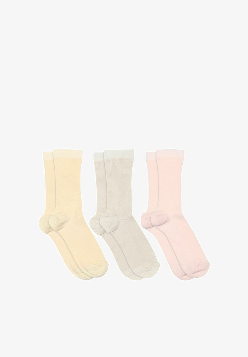 Trois paires de chaussettes courtes côtelées beige, gris clair et rose pâle, posées à plat côte à côte sur un fond blanc.