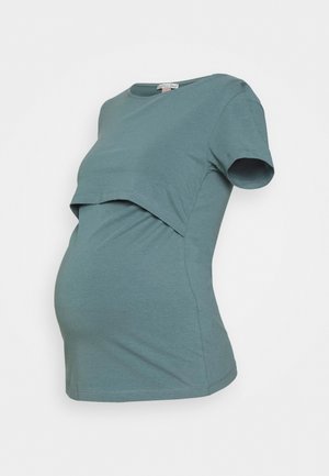 Maternity t-shirt in teal, short sleeves, features a layered design with a front flap for easy access, made of soft fabric, fitted at the waist.