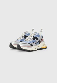 Chunky sports sneakers featuring a mix of blue, black, and silver with mesh overlays, textured rubber soles, and contrasting yellow accents.
