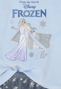 Elsa from Disney Frozen in a sparkly dress with flowing cape, snowflakes around, and "Frozen" and "Elsa" text on light blue fabric.