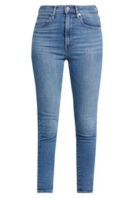 Jeans skinny de talle alto en denim azul claro con una textura suave, un ligero desvanecimiento y un diseño clásico de cinco bolsillos.