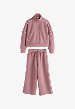 Mauve two-piece set with a cropped zip-up sweatshirt featuring white piping and matching wide-leg pants with side stripes and drawstring waist.