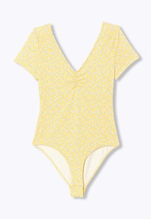Body jaune à manches courtes avec petit imprimé floral blanc, encolure en V et léger détail froncé au niveau de la poitrine.