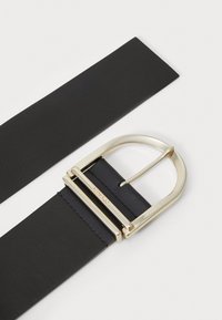 Black leather belt with a gold metal buckle. The buckle features a rectangular shape and a smooth finish, attached to a sleek strap.