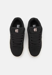 Black sneakers with a suede and textile upper, featuring laces, a rounded toe, beige sole, and pink logo accents on the tongue.