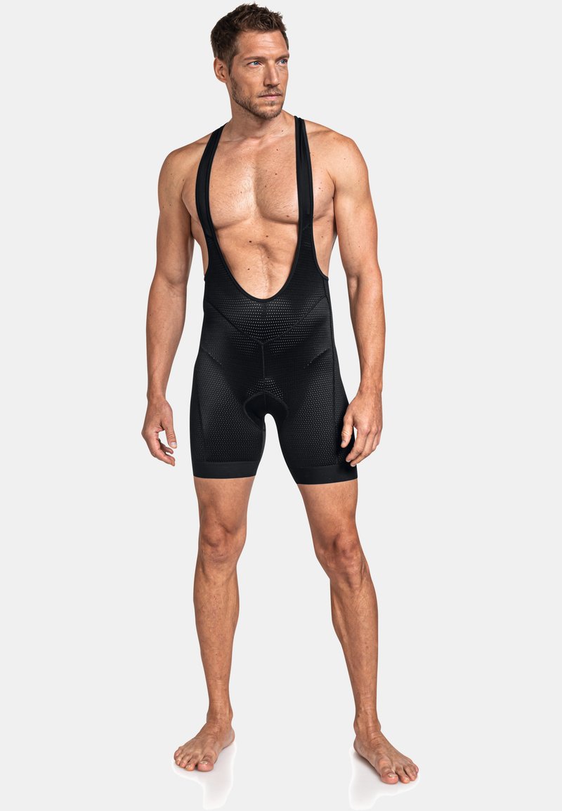 Schwarze Radsport-Bib-Shorts für Herren mit ärmellosem Design, strukturiertem Stoff und tiefem Ausschnitt. Mit gepolstertem Sitz für zusätzlichen Komfort.