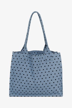Sac fourre-tout en tissu bleu avec motif de cœurs noirs et deux bretelles, forme rectangulaire, sans fermeture ou poches visibles.