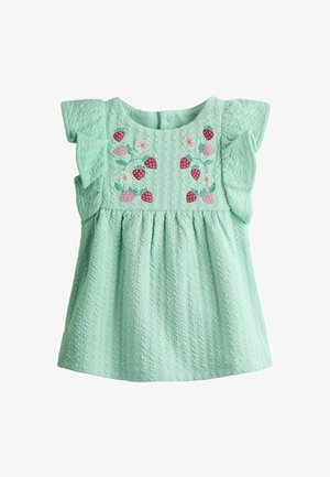 Mündiroheline tekstuuriga imikutekleit lipsuvate varrukatega ja rinnal tikitud maasikate ning valgete lilledega.