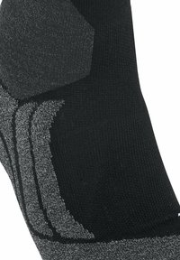 Calzino nero con accenti grigi texturizzati, dotato di aree rinforzate per la durabilità e una finitura in maglia liscia. Forma esagonale sul tallone.