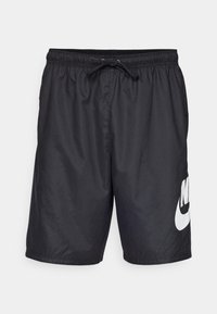 Black swim shorts made of lightweight material, featuring an elastic waistband with drawstring and a large white Nike logo on the left leg.