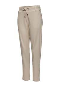 Beige joggerbroek gemaakt van een zachte stof, met een elastische tailleband met een trekkoord en zijzakken voor functionaliteit.