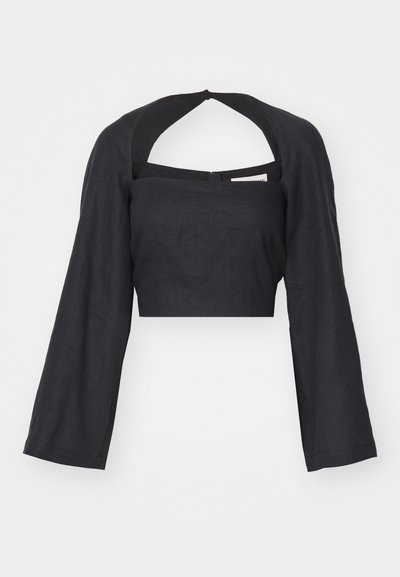 Mustast linast lühikeste varrukatega crop top, millel on ruudukujuline kaelus ja pikad, laiad varrukad. Tagaküljel on ava ja tõmblukk. Sile tekstuur.