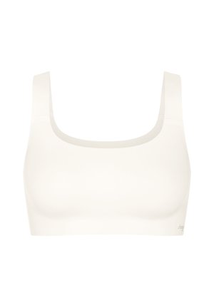 Brassière de sport blanche sans couture avec larges bretelles et encolure carrée, conçue pour le confort et le maintien.