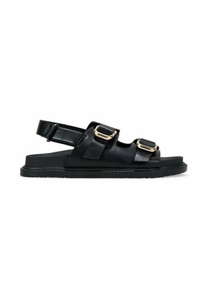 Sandalias de cuero negro con dos correas de hebilla, punta abierta y suela de goma plana. El diseño incluye una correa trasera para soporte.