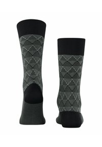 Gestrickte Socken in Dunkelgrün mit einem geometrischen Muster, ausgestattet mit einem schwarzen Bündchen und verstärkter Ferse. Das Material bietet Dehnbarkeit und Komfort.