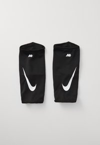 Manchons de genou en maille noire ornés d'un logo Nike Swoosh blanc prominent, conçus pour une utilisation athlétique avec une forme ajustée et une texture lisse.
