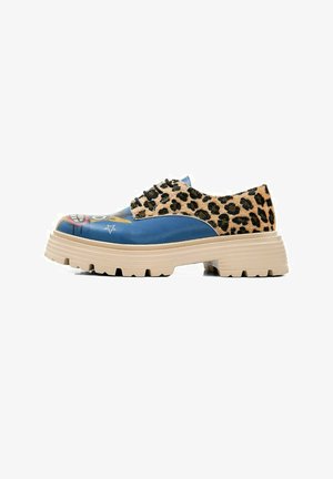 Blue and leopard print shoes with a chunky beige sole, featuring a graphic design on the toe and laces. Textured materials are present.