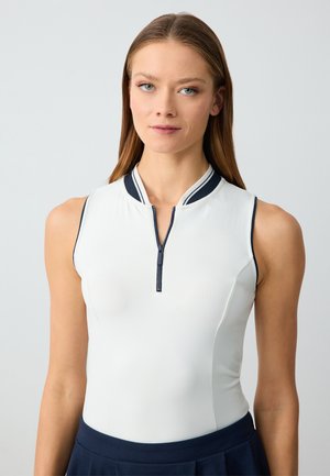 White sleeveless top with a front zipper and navy accents, featuring a high collar design. Smooth texture with a fitted silhouette.