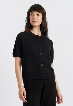 Black short-sleeve cardigan made of soft fabric, featuring a round neckline and a button front with textured ribbing along the edge.