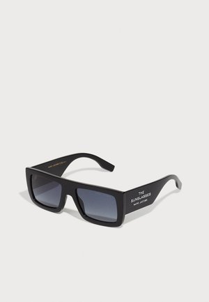 Black rectangular sunglasses with gradient lenses and bold front design. Features white text on the arm; smooth plastic frames.