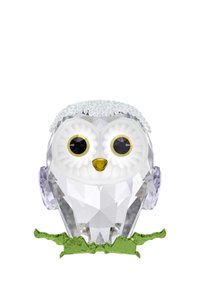 Priehľadná kráľovská figura sovy s veľkými bielymi očami, žltým zobákom, fialovými akcentmi na ušiach a zeleným podstavcom pripomínajúcim zeleň.
