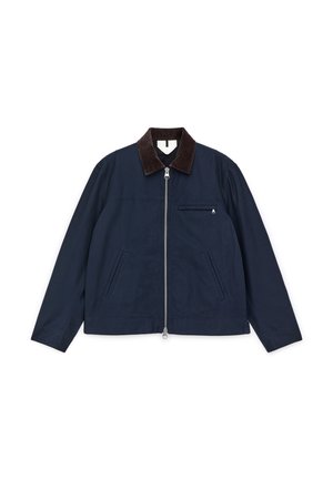 Mørkeblå bomuldsjakke med en brun fløjlskrave, lynlås foran og to sidelommer; har en lille brystlomme.