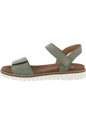 Green suede sandal with a flat sole, open toe, and adjustable ankle strap. Features a padded footbed and textured white outsole.