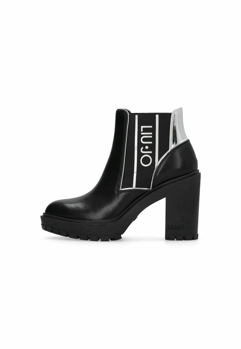 Bottine en cuir noir avec talon épais, détail argenté à l'arrière, et panneau élastique marqué "Liu Jo" en blanc sur fond noir.