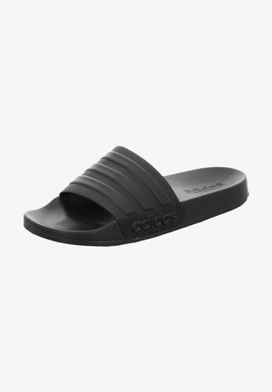 Black slide sandals with a textured strap featuring three raised horizontal lines, sturdy rubber sole, and embossed logo detail on the side.