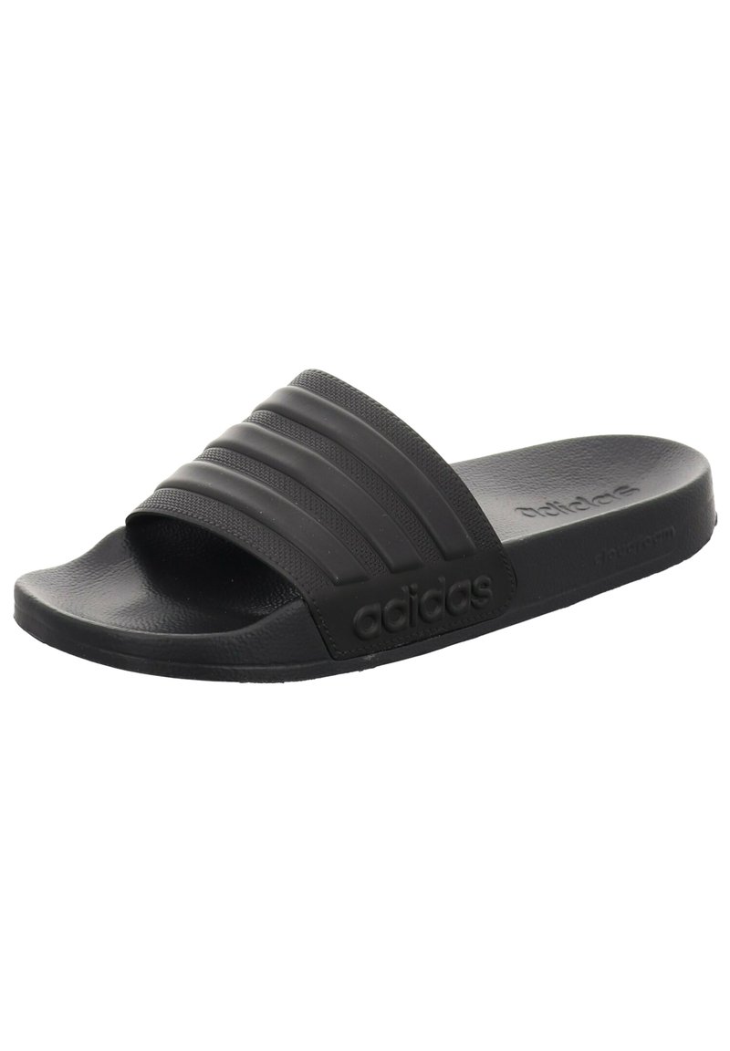 Black slide sandals with a textured strap featuring three raised horizontal lines, sturdy rubber sole, and embossed logo detail on the side.