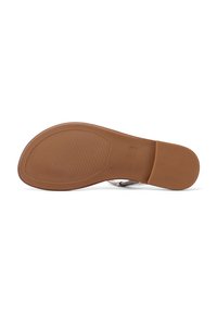 Suola in gomma marrone con grip testurizzato e motivo circolare. Cinghie argento si integrano in un design minimale, offrendo stabilità e comfort.