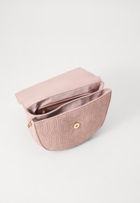 Roze leren schoudertas met geperst logopatroon, gouden beslag en een open compartiment met een gladde voering en een ritssluitingvak.