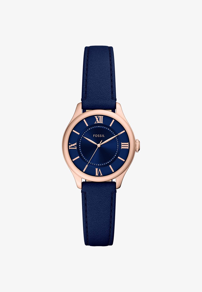 Boîtier de montre rond en or rose avec cadran bleu, chiffres romains, trois aiguilles et bracelet en cuir bleu. Nom de la marque "Fossil" sur le cadran.