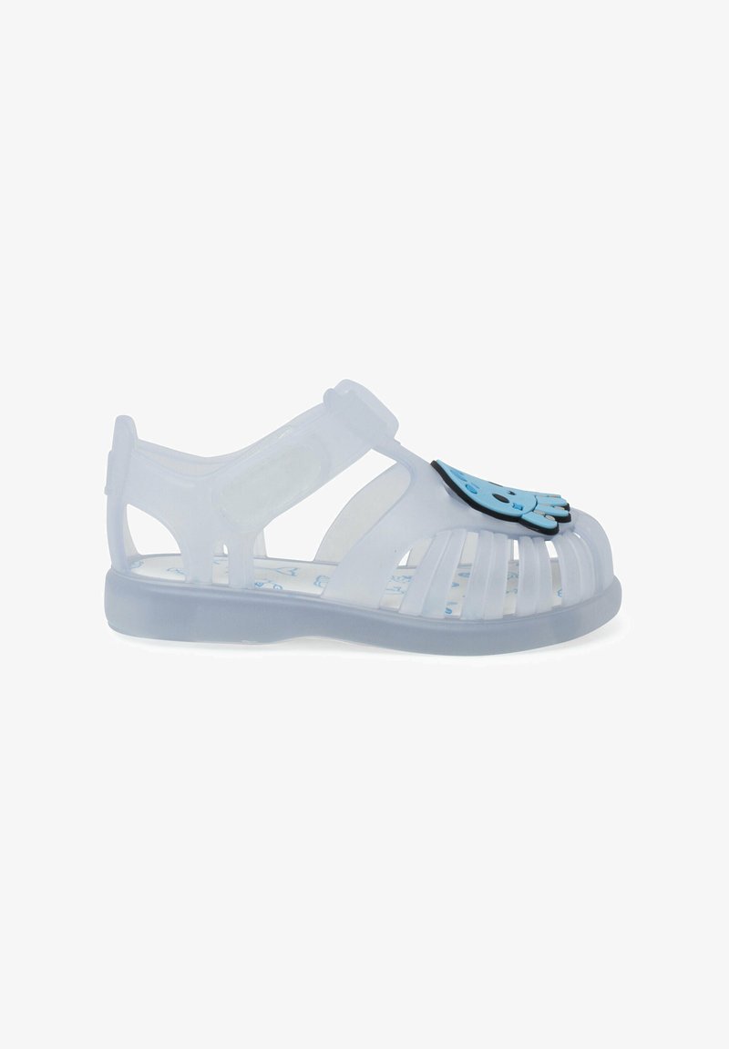 Clear plastic sandal with open design, featuring a blue character accent on the toe. Adjustable strap for a secure fit.