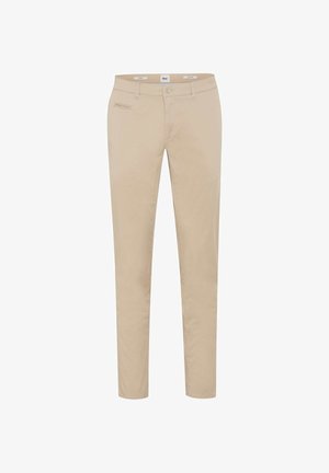 Beige slim-fit broek met ceintuurlussen, knoop- en ritssluiting aan de voorkant, en een klein horizontaal ritssluitvak aan de rechterzijde.