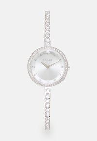 Orologio da polso argento con quadrante rotondo, dettagli in cristallo attorno alla lunetta e un bracciale tempestato di gemme. Presenta un quadrante minimalista con lancette argentate.