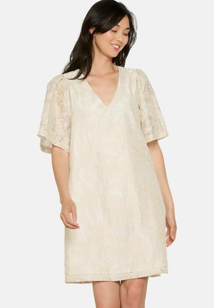 Cream-colored dress with a V-neck and short, puffed sleeves. Features floral texture and an A-line silhouette for a loose fit.