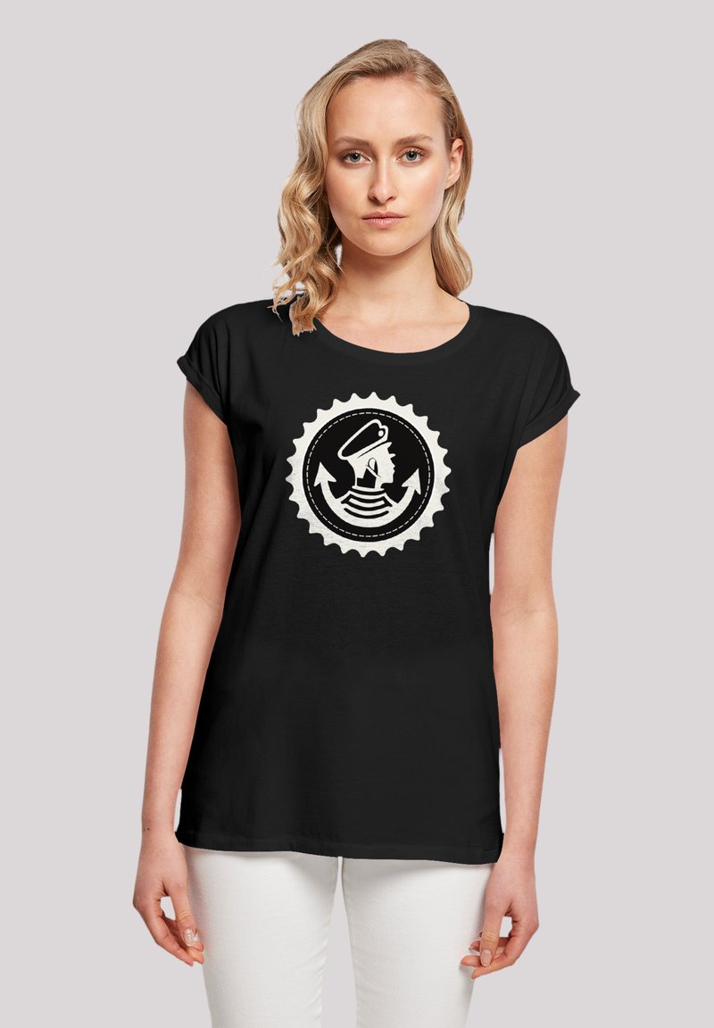 Black short-sleeve t-shirt featuring a circular graphic design with a helmeted figure, arrows, and wavy lines in white. Soft fabric.