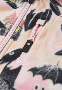 Fleece jacket with a pink and black floral pattern, featuring a pink zipper and black snap detail on the front. Soft texture.