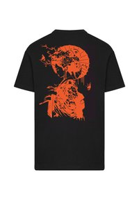 Black T-shirt featuring an orange graphic design of a woman's face with a fan and floral elements, displayed on the back.