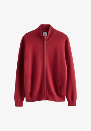 Raudonas zip-up megztinis su aukšta struktūruota apykakle, ilgomis rankovėmis ir dviem priekinių kišenių. Minkšta medžiaga su lygiu paviršiumi.
